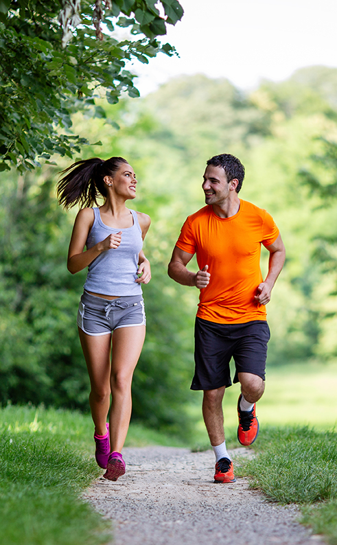 Portrait of happy fit people running together ourdoors. Couple sport healthy lifetsyle concept
